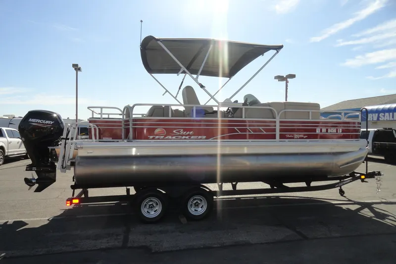 Slide: The Image of 2022 Sun Tracker Fishin' Barge 20 DLX pontoon boat with canopy and Mercury outboard motor. - 5
