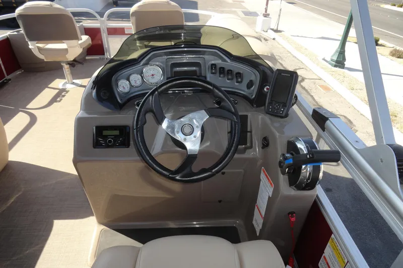 Slide: The Image of 2022 Sun Tracker Fishin' Barge 20 DLX dashboard with steering wheel and controls. - 8