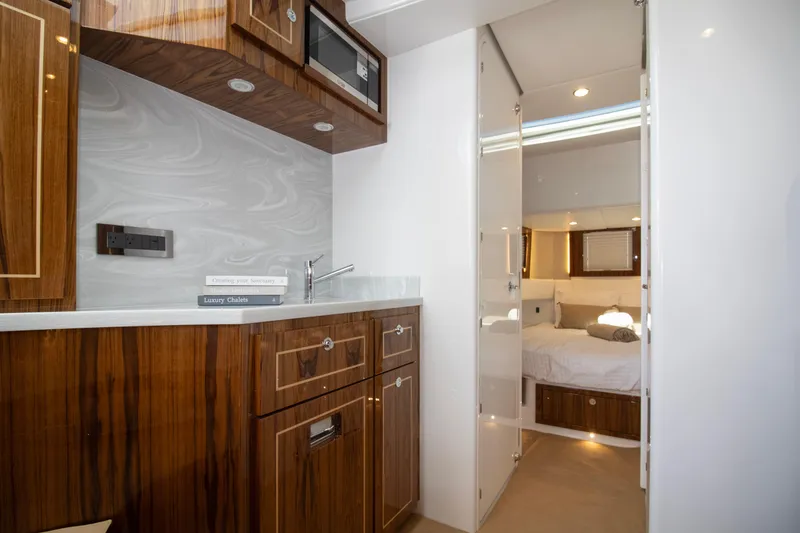 Slide: The Image of Luxurious interior of 2025 HCB 56 Suenos GIX yacht with wood cabinetry and modern design. - 5