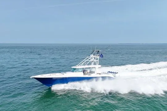 Slide: The Image of 2025 HCB 56 Suenos GIX cruising on open water, showcasing sleek design and performance. - 0