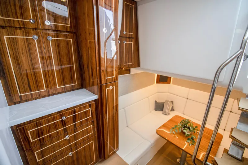 Slide: The Image of Luxurious interior of 2025 HCB 56 Suenos GIX yacht with elegant wood cabinetry and cozy seating area. - 6