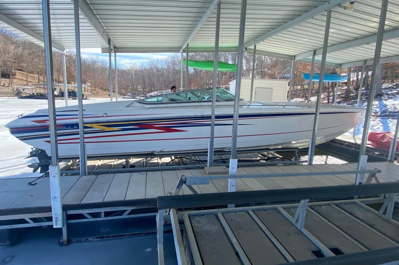 The Image of 2006 Formula 353 FASTech boat docked under a covered marina. - 1