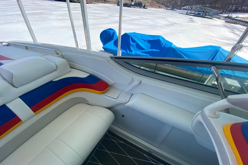Slide: The Image of 2006 Formula 353 FASTech boat interior with colorful seating, docked near a frozen lake. - 11