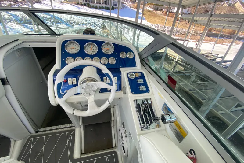 Slide: The Image of 2006 Formula 353 FASTech boat cockpit with steering wheel and control panel. - 12