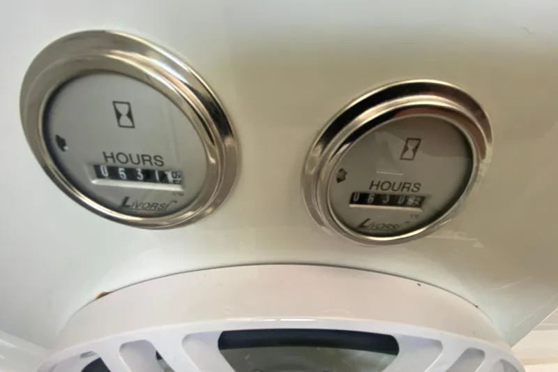 Slide: The Image of Hour meters on a 2006 Formula 353 FASTech boat dashboard, showing usage hours. - 24