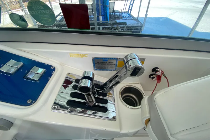 Slide: The Image of 2006 Formula 353 FASTech boat controls with chrome levers and blue panel. - 25