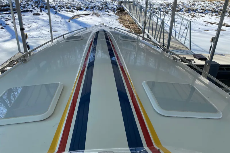 Slide: The Image of 2006 Formula 353 FASTech boat with colorful stripes docked in snowy surroundings. - 30
