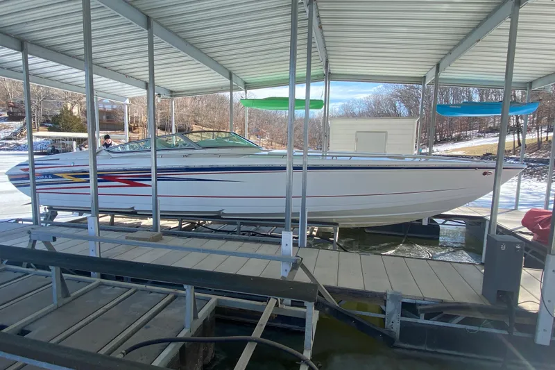 Slide: The Image of 2006 Formula 353 FASTech boat docked under a covered marina. - 38