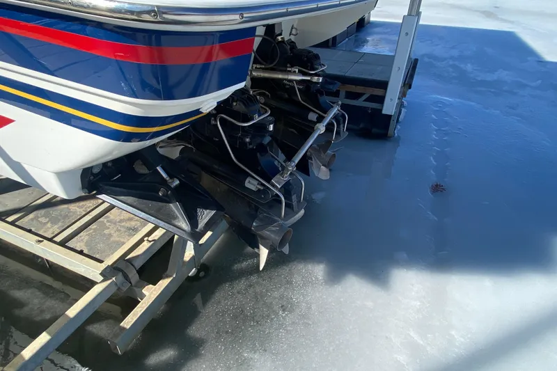 Slide: The Image of 2006 Formula 353 FASTech boat on icy surface, showcasing dual outboard motors. - 4