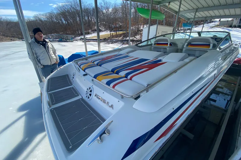 Slide: The Image of 2006 Formula 353 FASTech boat docked, featuring colorful seating and sleek design. - 6