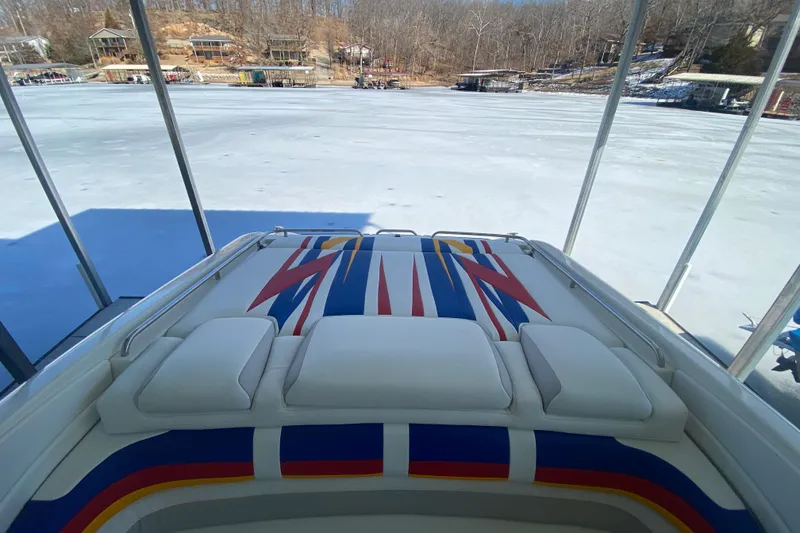Slide: The Image of 2006 Formula 353 FASTech boat with colorful upholstery, docked on a frozen lake. - 8