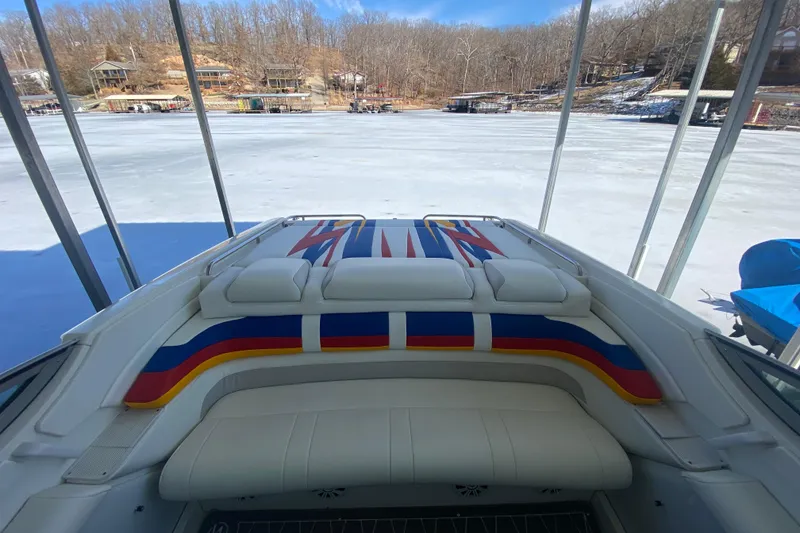 Slide: The Image of 2006 Formula 353 FASTech boat with colorful seating, docked by a frozen lake. - 9