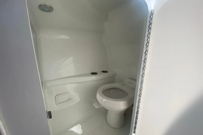 Slide: The Image of Interior of a 2006 Formula 353 FASTech boat bathroom with white fixtures. - 24
