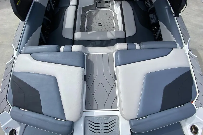 Slide: The Image of 2018 Malibu Wakesetter 22 MXZ interior with gray and blue seating. - 2