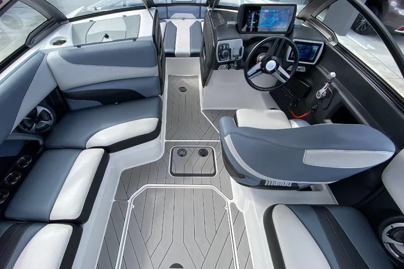 Slide: The Image of 2018 Malibu Wakesetter 22 MXZ interior with modern dashboard and seating. - 4