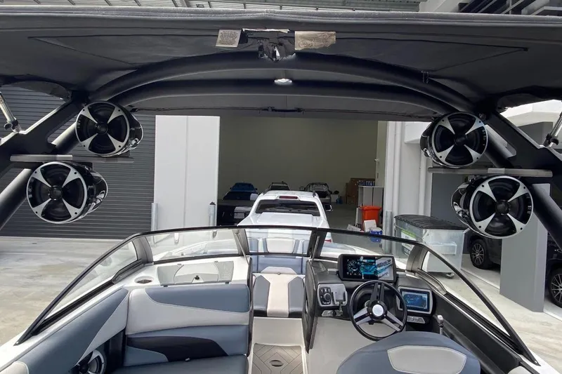 Slide: The Image of 2018 Malibu Wakesetter 22 MXZ interior with advanced audio system and sleek dashboard design. - 5