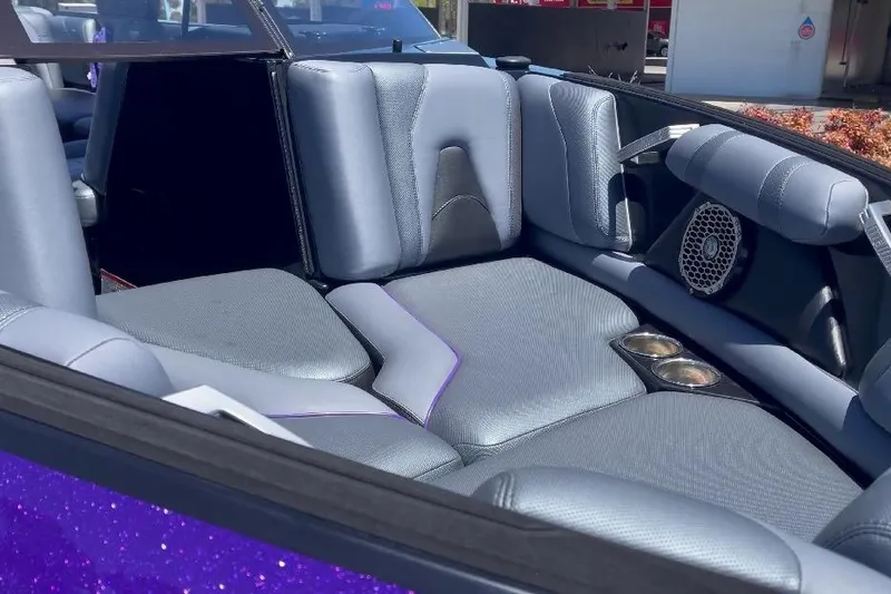 Slide: The Image of 2018 Malibu Wakesetter 21 VLX interior with gray seating and built-in speakers. - 3