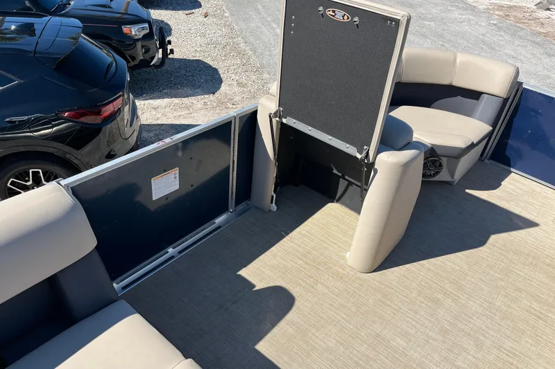 Slide: The Image of 2024 Harris Cruiser 230 interior with beige seating and carpeted flooring. - 10