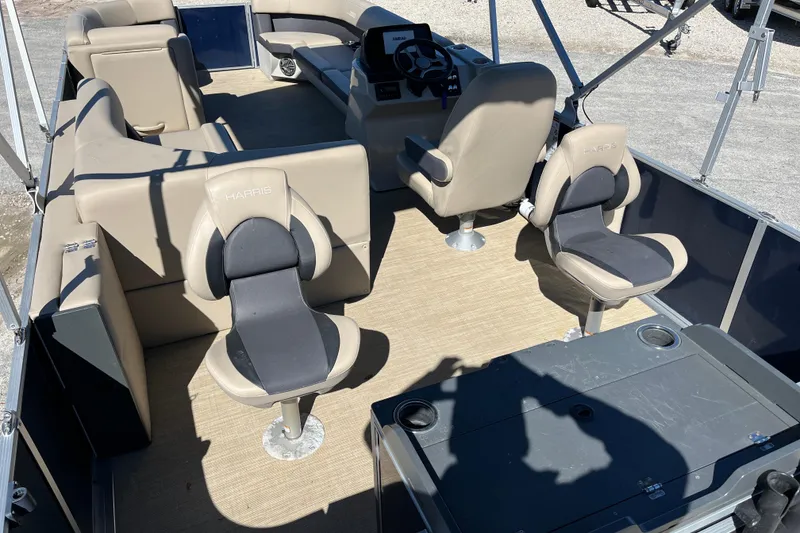 Slide: The Image of 2024 Harris Cruiser 230 interior with beige seating and steering console. - 13