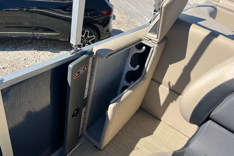 Slide: The Image of 2024 Harris Cruiser 230 interior with beige seating and cup holders. - 14