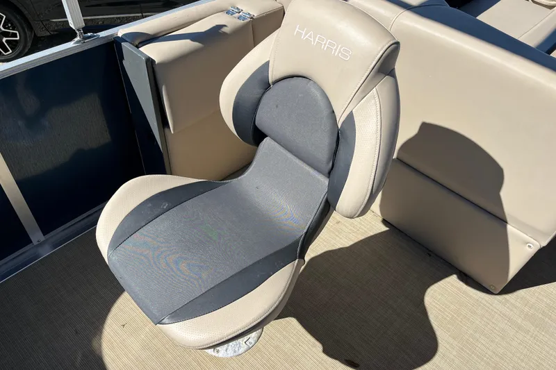 Slide: The Image of 2024 Harris Cruiser 230 boat seat, beige and gray, with "Harris" branding. - 15