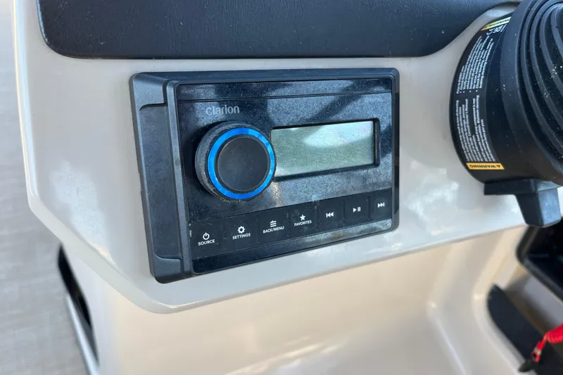 Slide: The Image of 2024 Harris Cruiser 230 dashboard with Clarion audio system. - 19