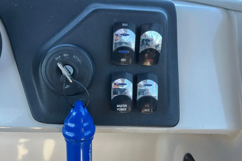 Slide: The Image of Control panel of 2024 Harris Cruiser 230 boat with ignition and switches. - 21