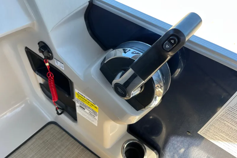Slide: The Image of 2024 Harris Cruiser 230 boat throttle control with safety features and warning labels. - 22