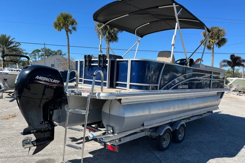 Slide: The Image of 2024 Harris Cruiser 230 pontoon boat with Mercury engine on trailer. - 5