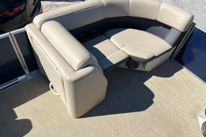 Slide: The Image of 2024 Harris Cruiser 230 boat interior with beige seating and cup holders. - 8