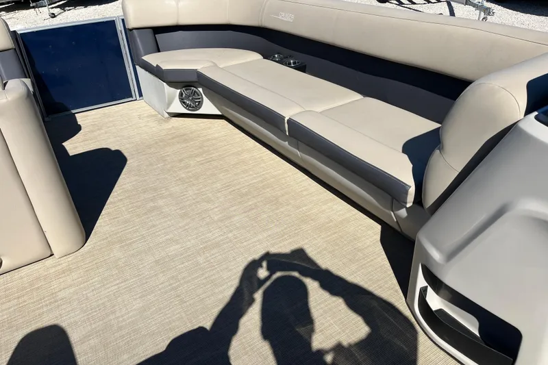 Slide: The Image of 2024 Harris Cruiser 230 interior with beige seating and spacious deck. - 9