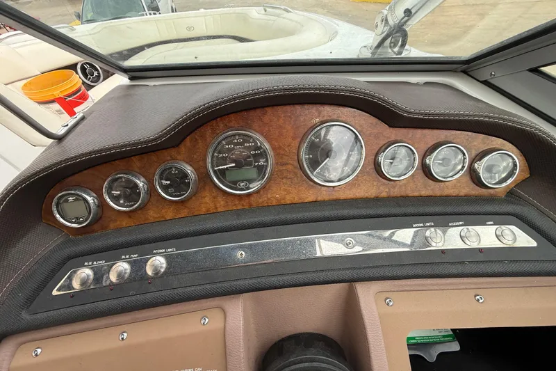 Slide: The Image of Dashboard of a 2011 Cobalt 242 boat with gauges and controls. - 10