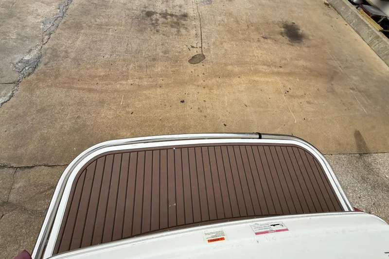 Slide: The Image of 2011 Cobalt 242 boat swim platform on concrete surface. - 11