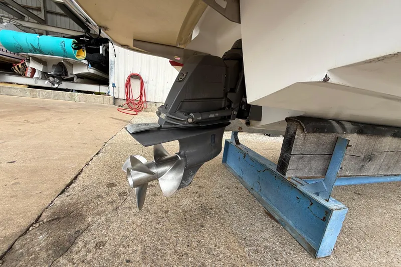 Slide: The Image of 2011 Cobalt 242 boat propeller and stern drive in a storage facility. - 13