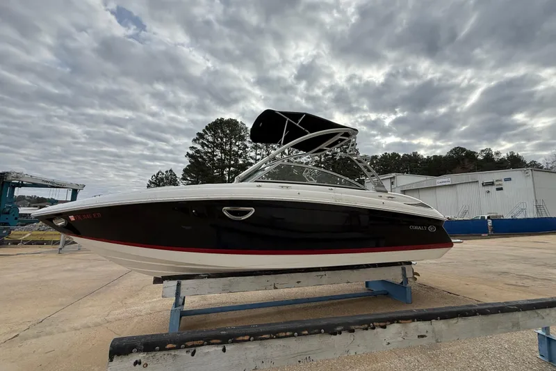Slide: The Image of 2011 Cobalt 242 boat on a trailer under cloudy skies. - 3