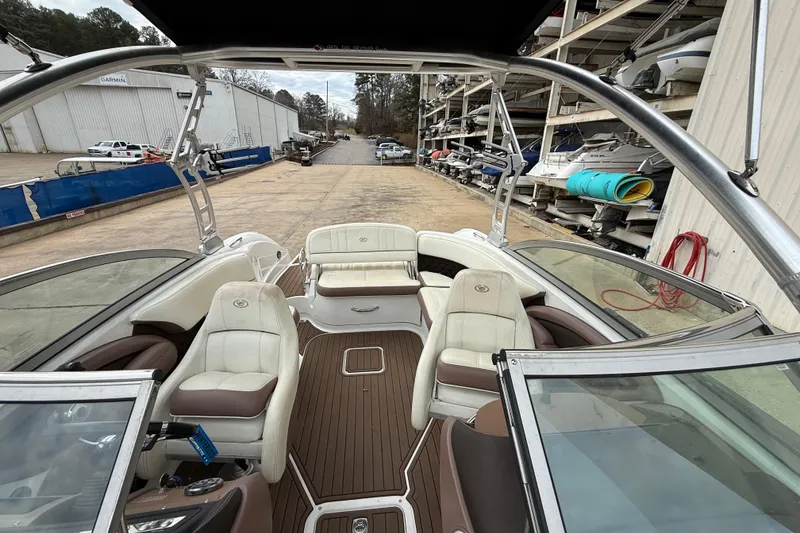 Slide: The Image of 2011 Cobalt 242 boat interior with seating, docked at a marina. - 8