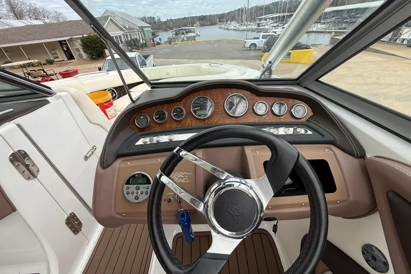 Slide: The Image of Steering wheel and dashboard of a 2011 Cobalt 242 boat at a marina. - 9