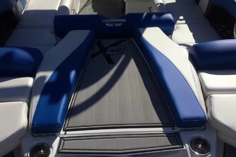 Slide: The Image of 2018 MasterCraft X46 boat interior with blue and white seating. - 3