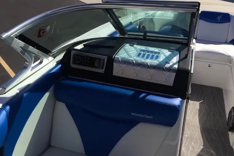 Slide: The Image of 2018 MasterCraft X46 boat interior with blue and white seating and modern dashboard. - 4