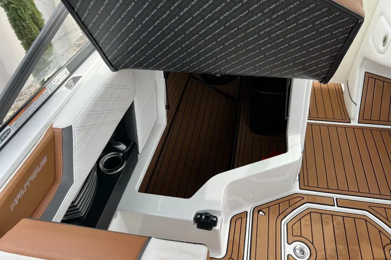 Slide: The Image of 2018 Nautique Super Air Nautique G23 interior with teak flooring and storage compartment. - 10