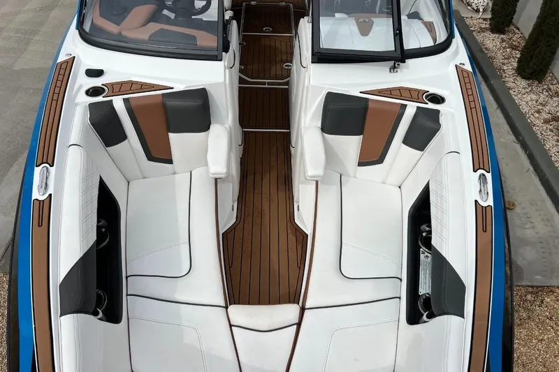 Slide: The Image of 2018 Nautique Super Air Nautique G23 boat interior with white and brown seating. - 16
