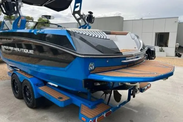 Slide: The Image of 2018 Nautique Super Air Nautique G23 boat, blue exterior, on trailer, rear view. - 3