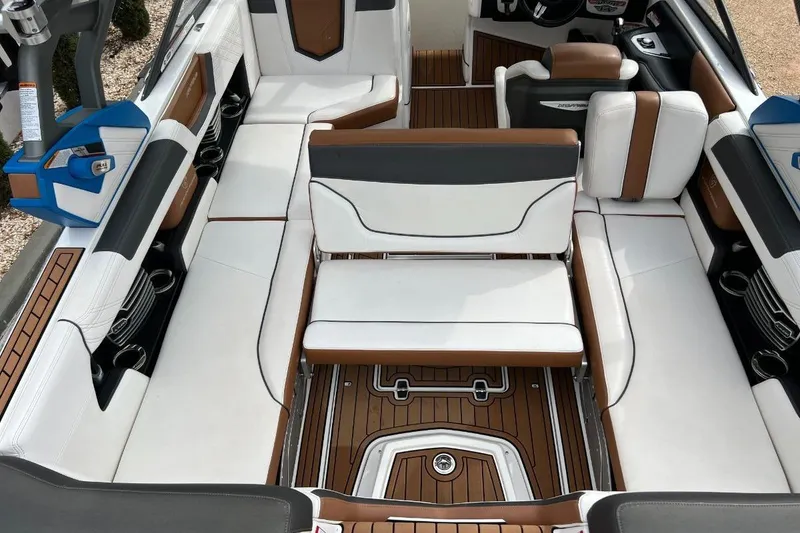 Slide: The Image of 2018 Nautique Super Air Nautique G23 interior with white and brown seating, stylish design. - 7