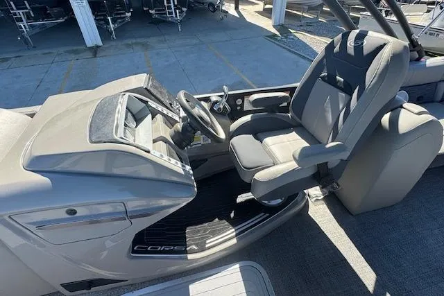 Slide: The Image of 2024 Barletta CORSA 25 QSSA boat cockpit with steering wheel and captain's chair. - 16