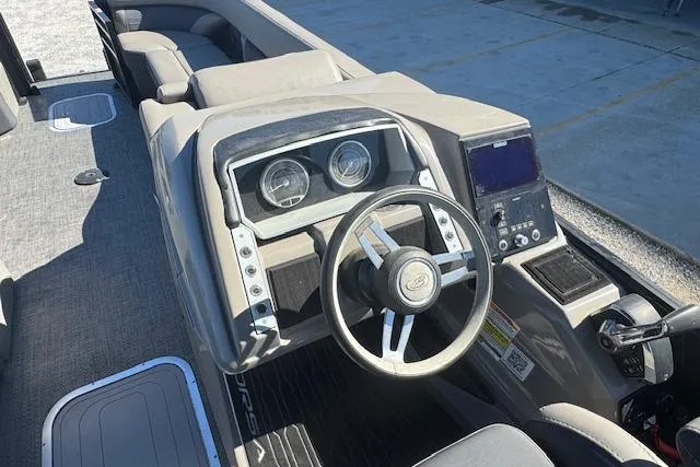 Slide: The Image of 2024 Barletta CORSA 25 QSSA boat dashboard with steering wheel and control panel. - 17