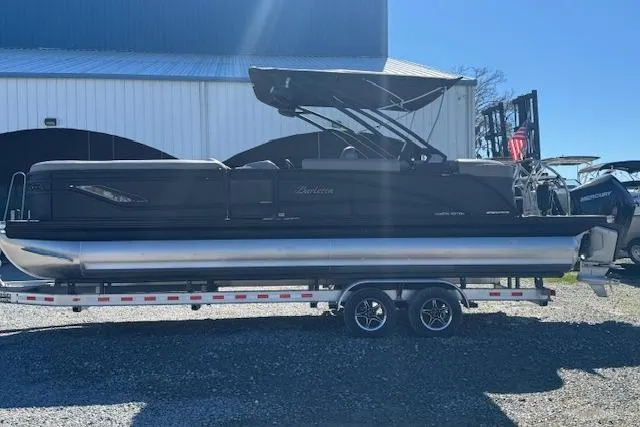 Slide: The Image of 2024 Barletta CORSA 25 QSSA pontoon boat on trailer, parked outdoors. - 7