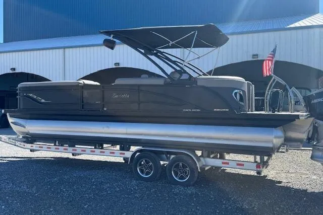Slide: The Image of 2024 Barletta CORSA 25 QSSA pontoon boat on trailer, parked outdoors. - 8