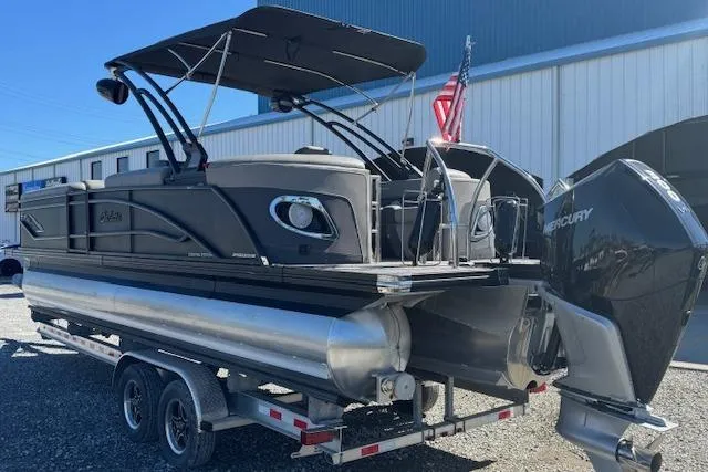 Slide: The Image of 2024 Barletta CORSA 25 QSSA pontoon boat on trailer with Mercury outboard motor. - 9