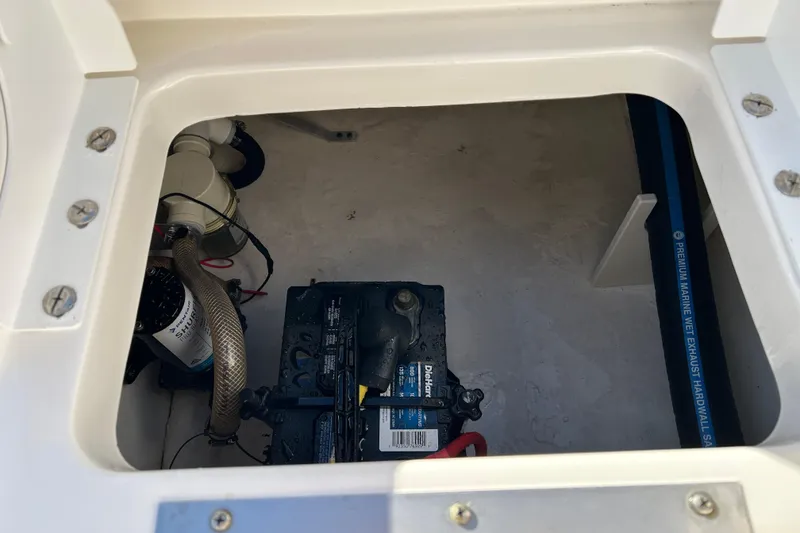 Slide: The Image of 2016 Robalo R200 Center Console boat battery compartment with marine equipment. - 16