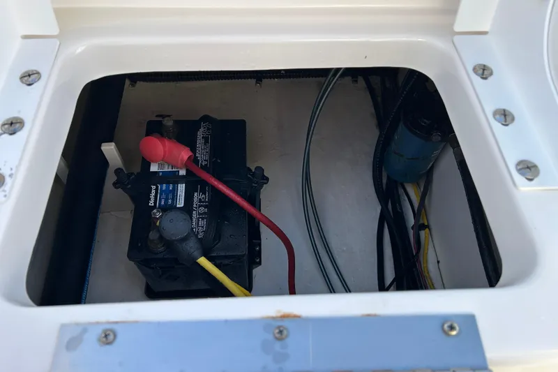 Slide: The Image of Battery compartment of a 2016 Robalo R200 Center Console boat, showing wiring and connections. - 17